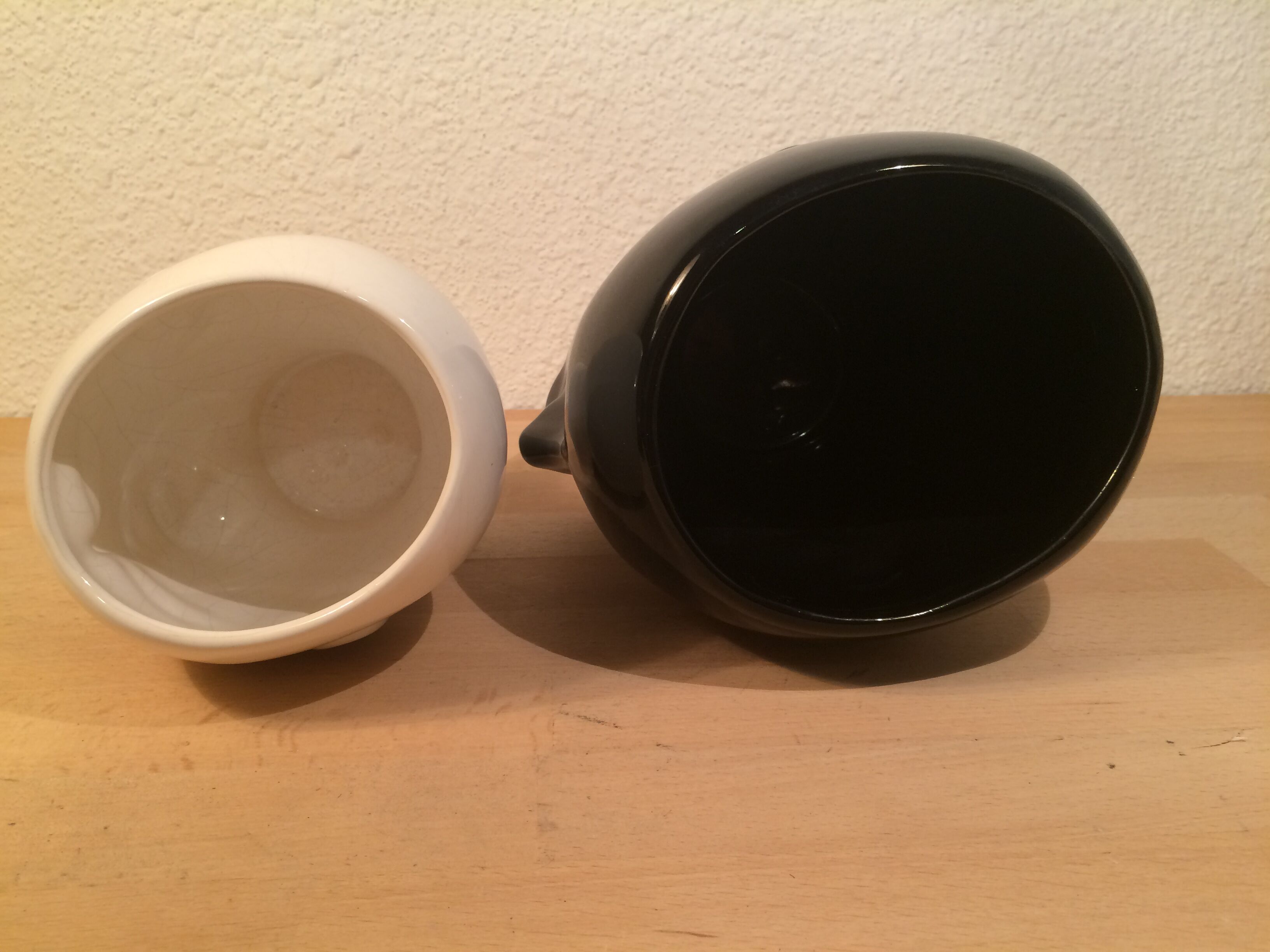 2 black and white ceramic head vases, face