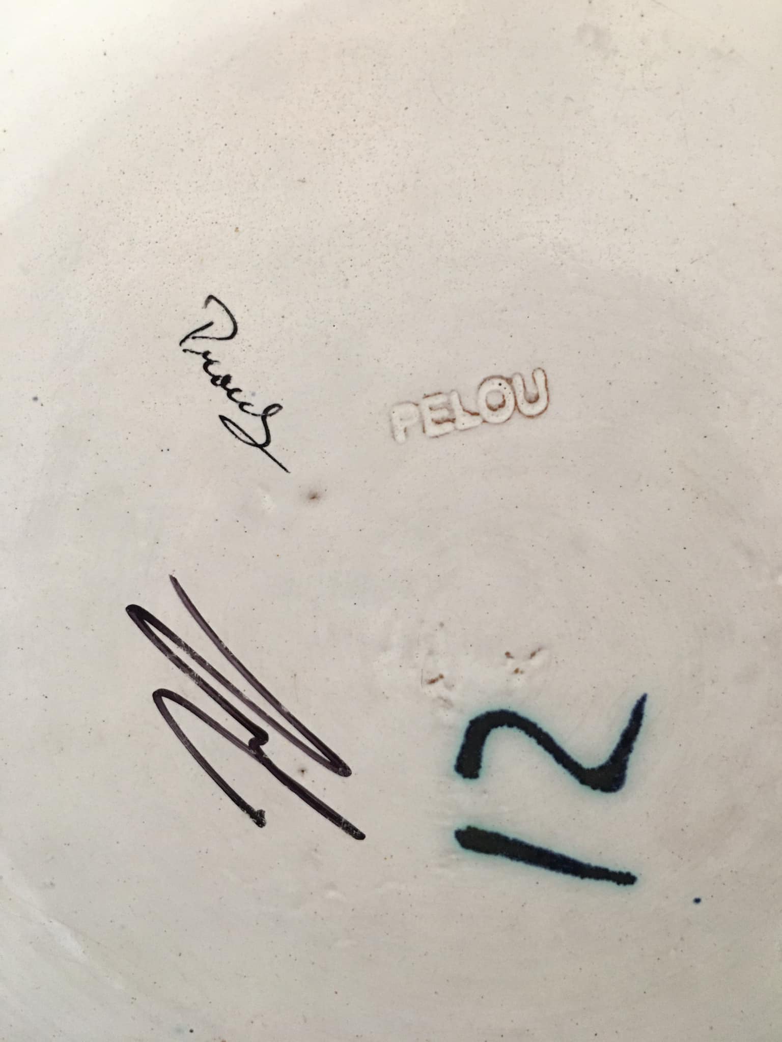 Glazed ceramic plate representation man between two lands unknown signature