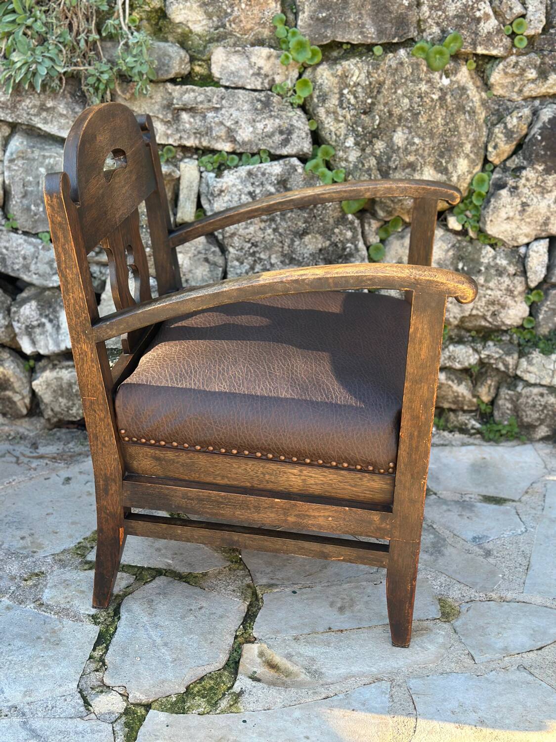 Pair of armchairs in stained wood and leather, 20th century