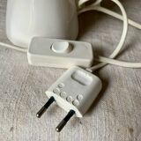 Ceramic table lamp depicting two hands holding a globe, 1980