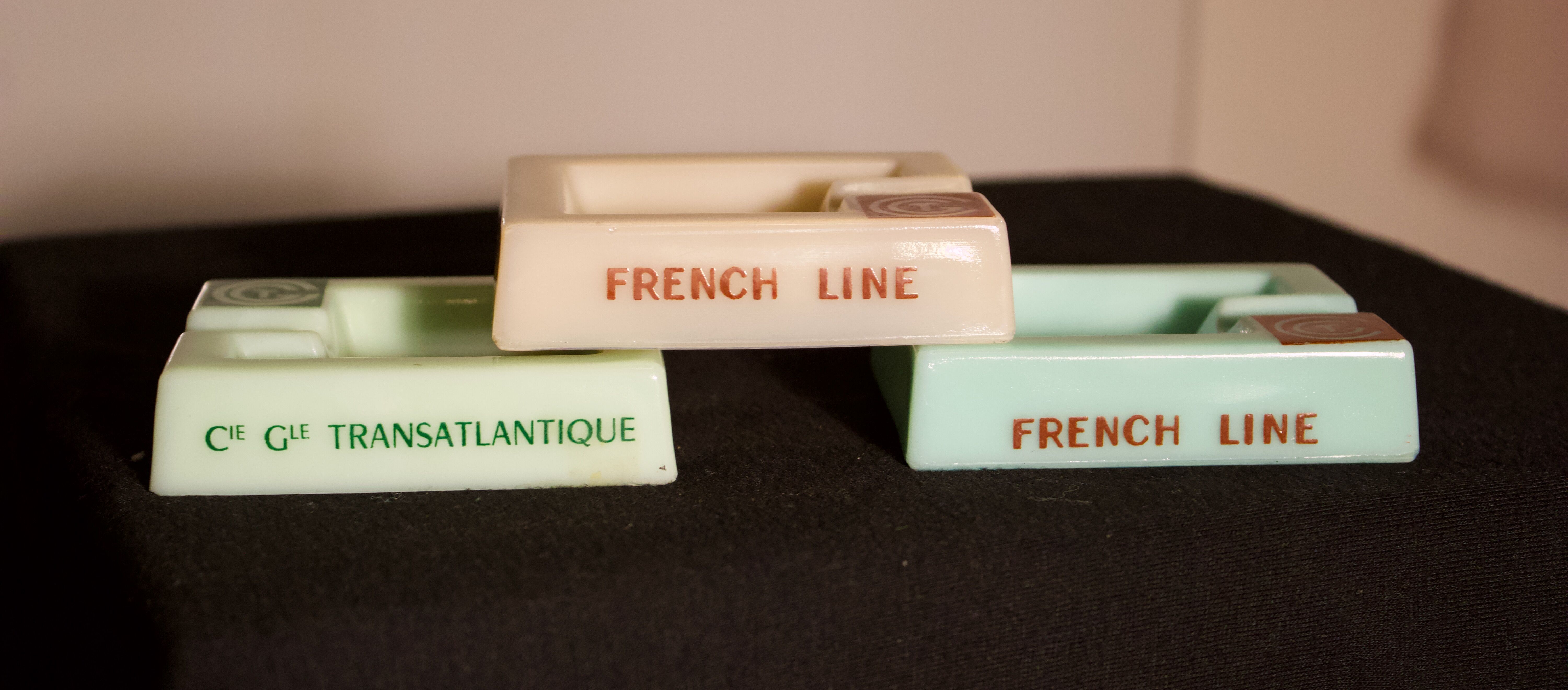 Three opalex ashtrays at the Logo of the Trans-Atlantic General Company - French Line - Model created by Jean Luce for the cruises of the liner Normandy and France