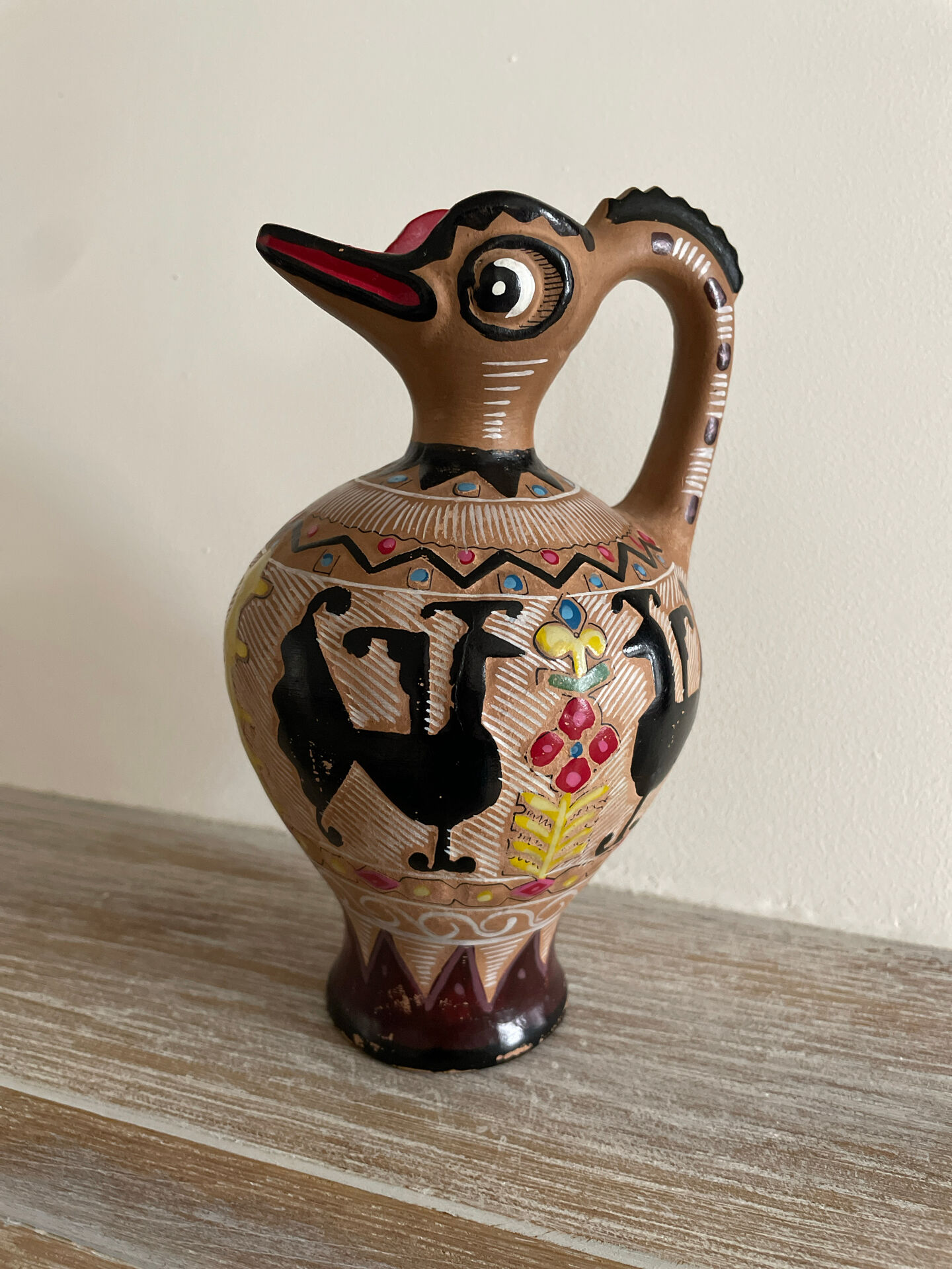 Clay pitcher with a bird head