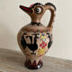 Clay pitcher with a bird head