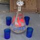Peacock pattern liqueur decanter and 4 small vintage cobalt blue glasses