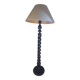 Sculptural floor lamp made of twisted turned wood.