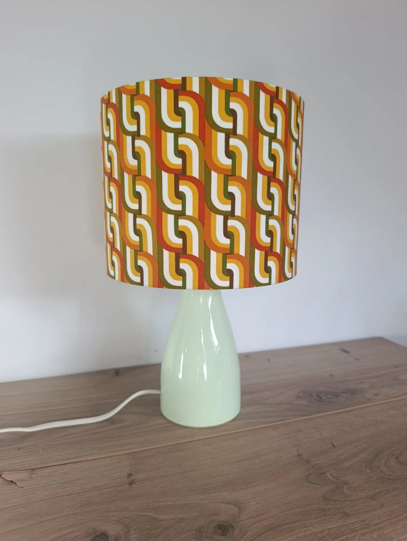 Seventies spirit lamp with geometric orange/green lampshade.