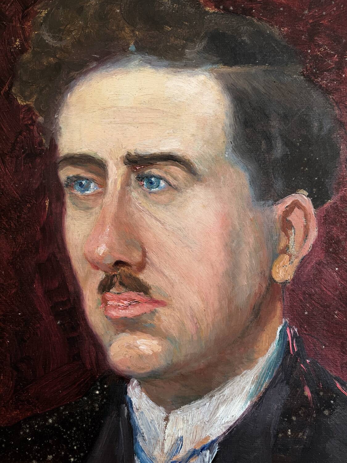 Old oil painting on cardboard portrait of a man in a dark suit