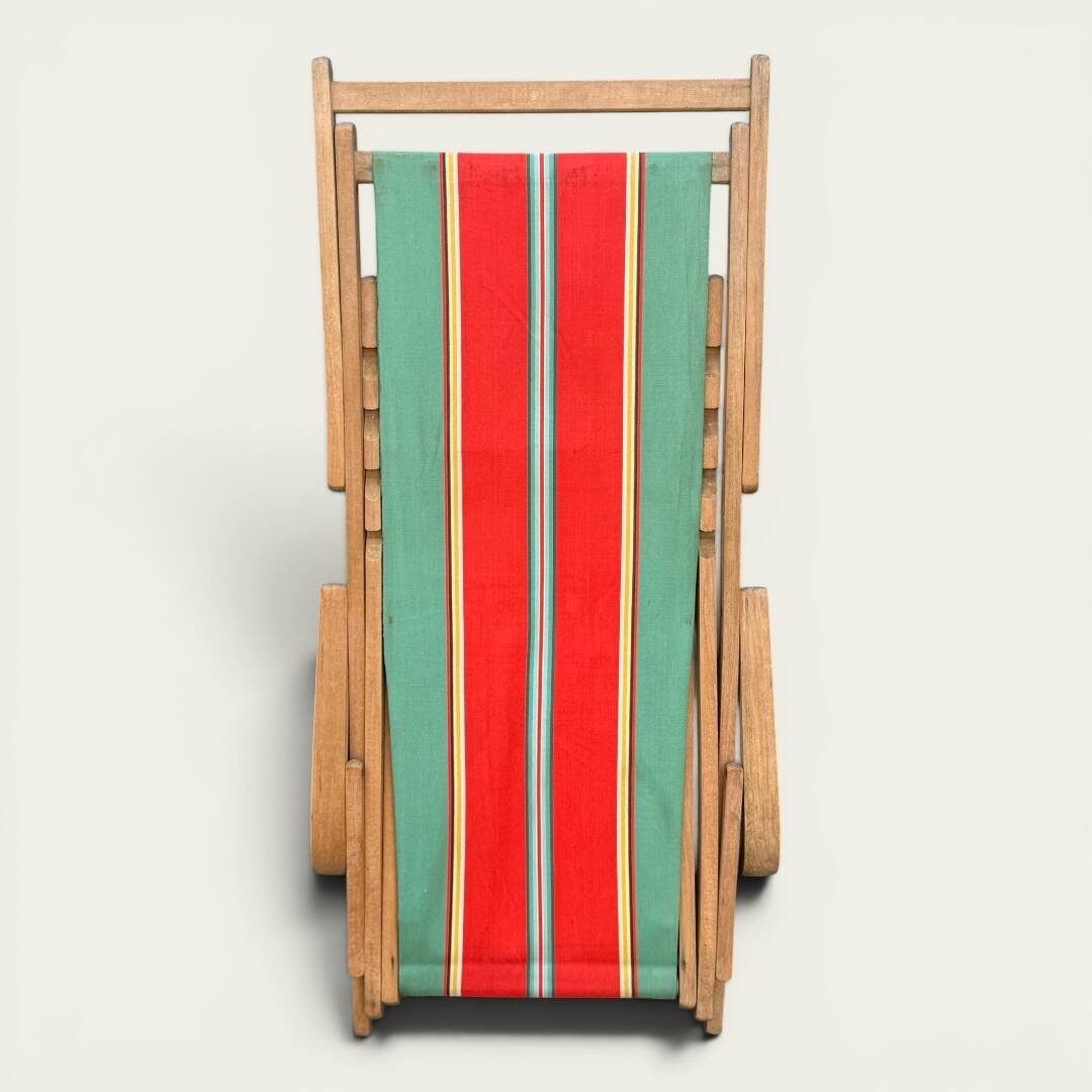 Vintage deck chair with striped green and red fabric, original patina.