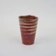 Small orange glazed ceramic cup