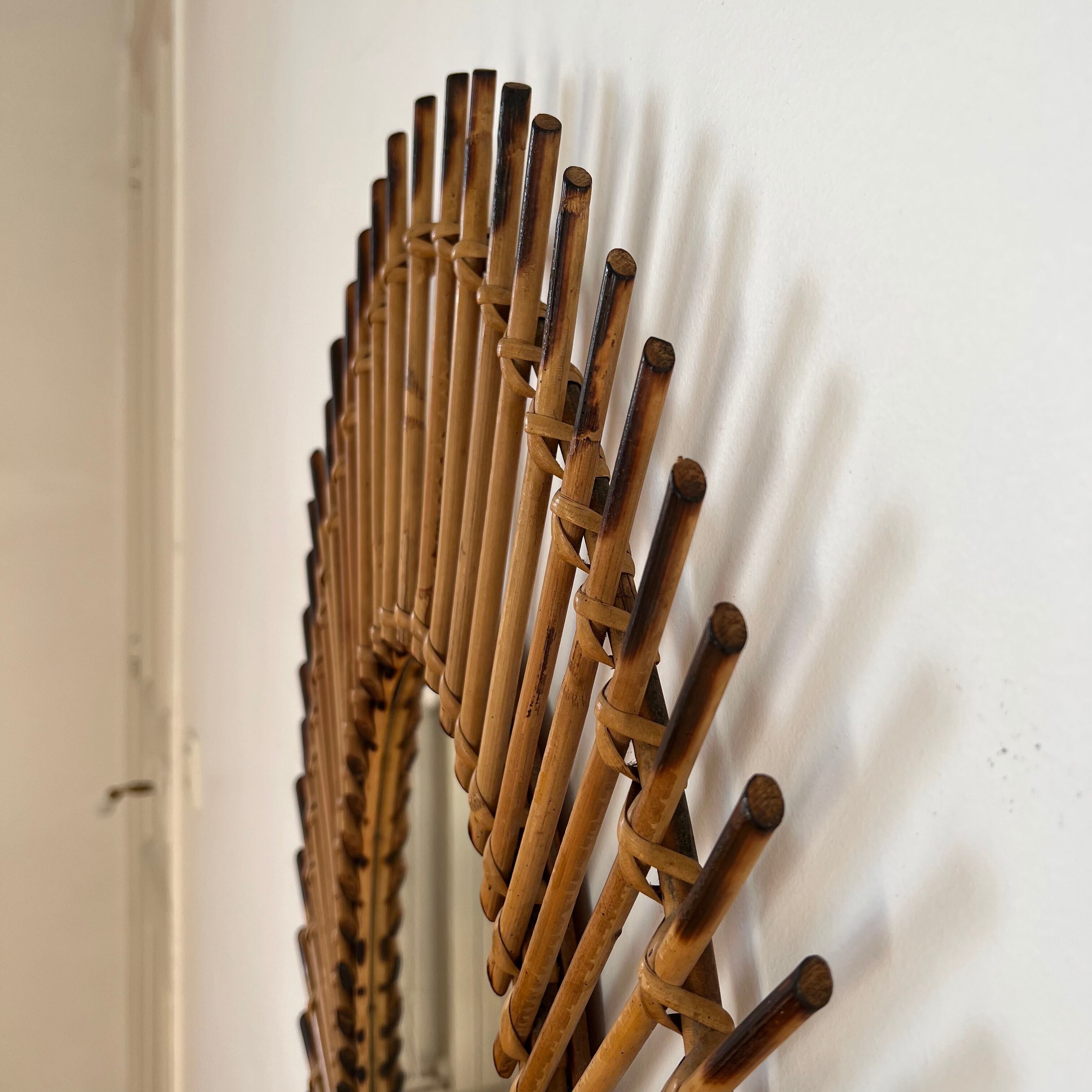 Rattan mirror in the shape of an eye