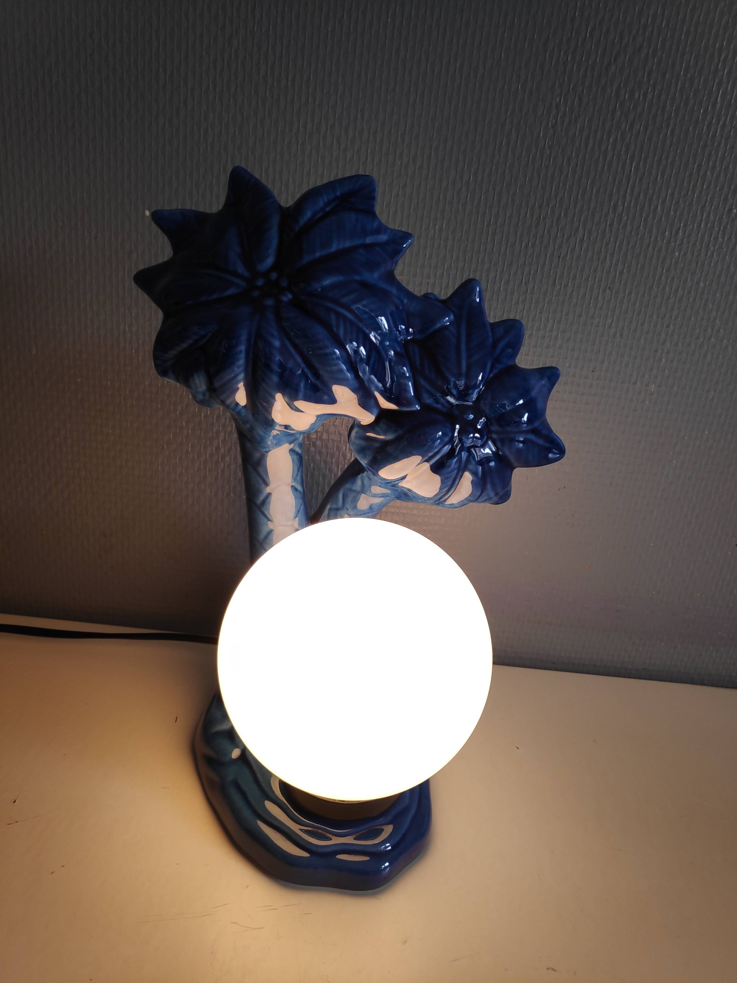 Blue ceramic palm lamp and white opaline globe