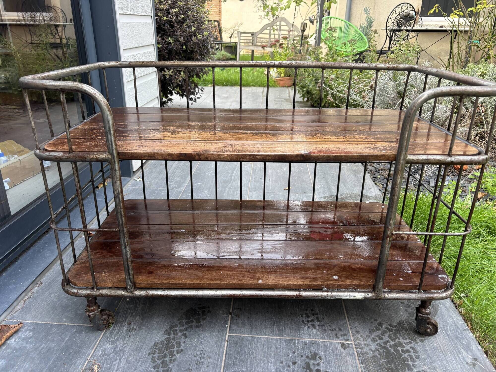 Industrial metal and wood serving trolley on wheels