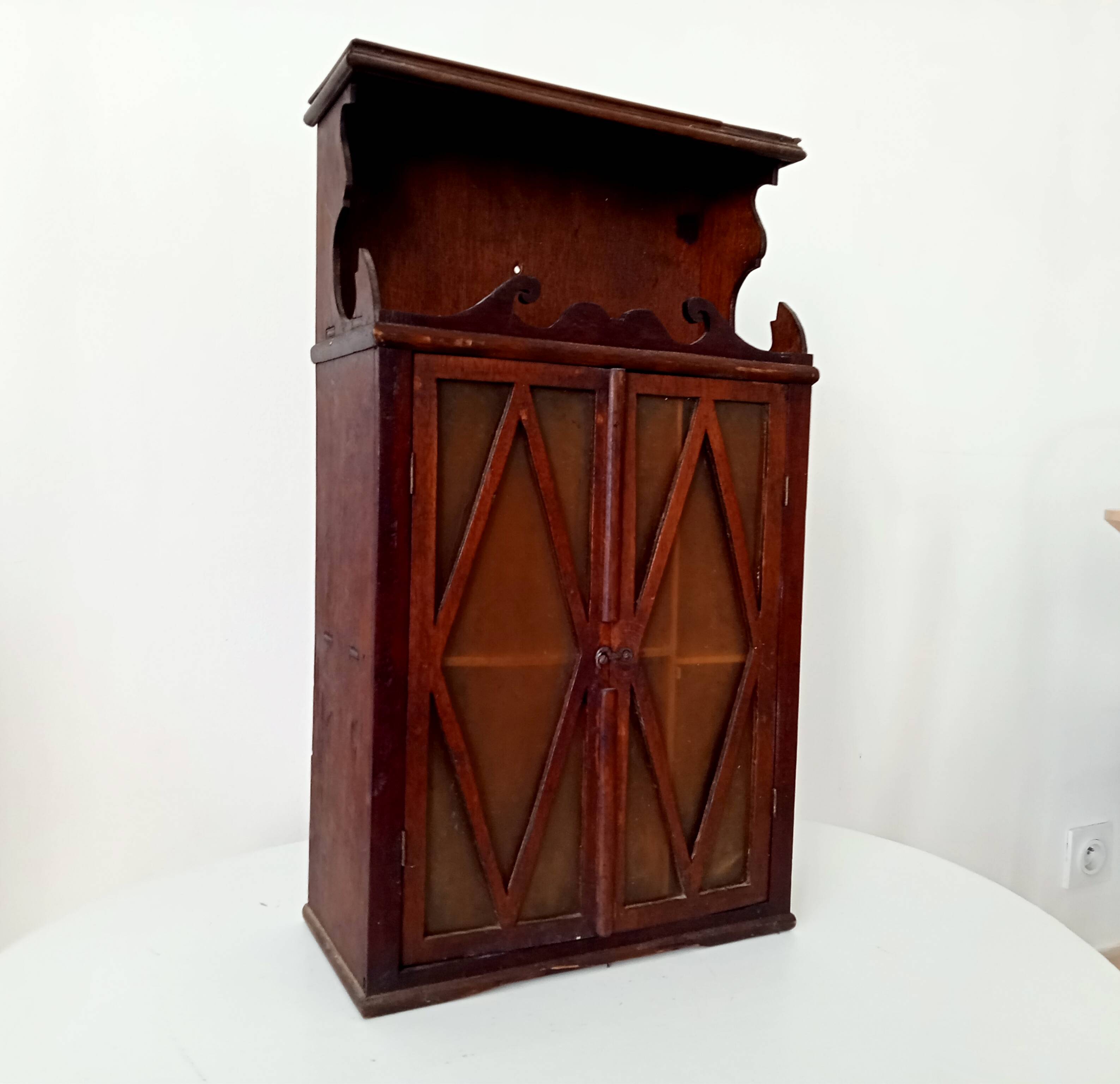 Small antique wall cabinet in Gothic style.