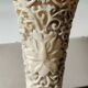 Asian-inspired ball vase. In beige cinnabar lacquer. Scenes of life decor. Arabesque and floral friezes. Height 24 cm