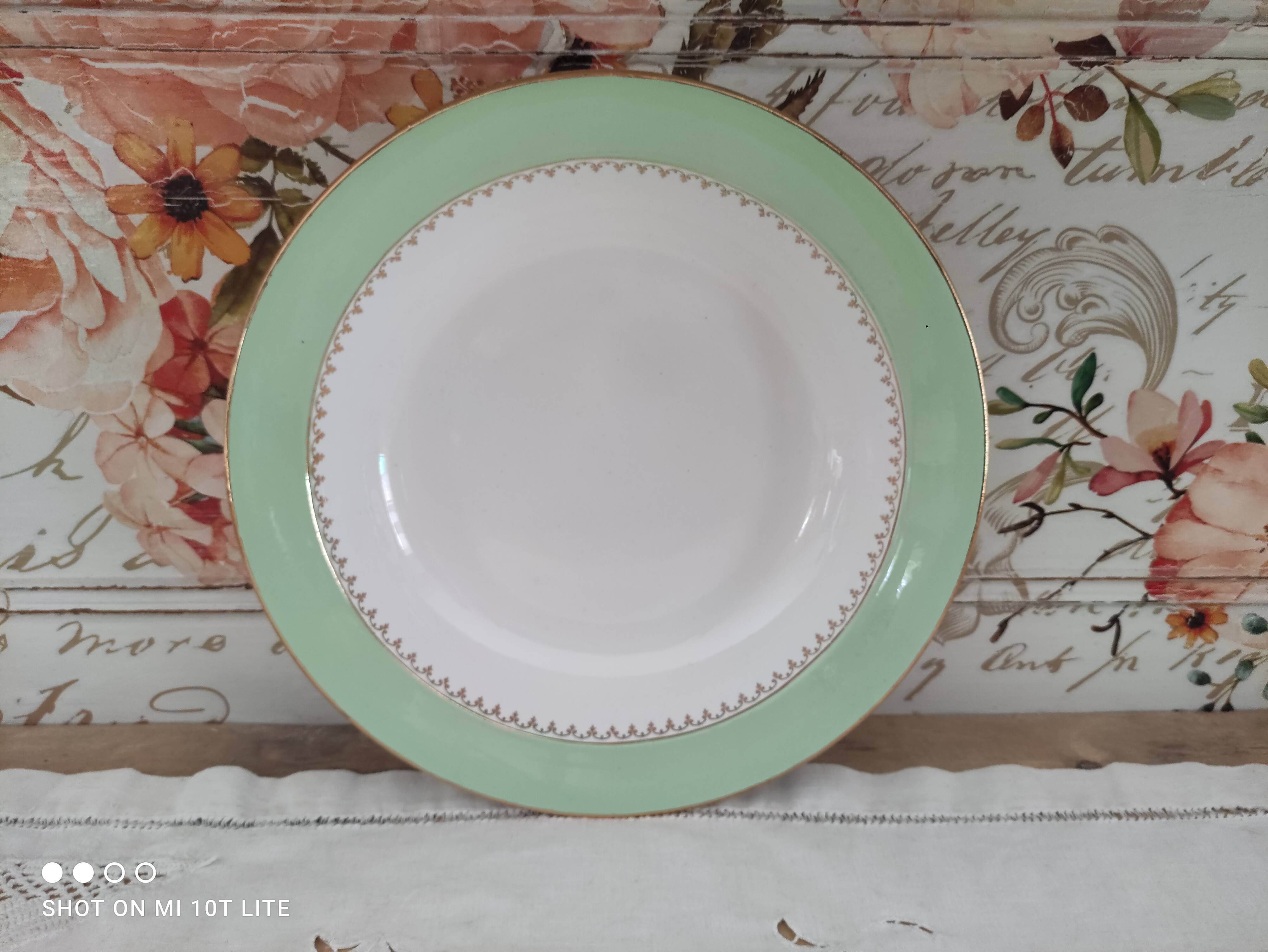 Round hollow plate in water green with a golden frieze, Cafés Lemaire.