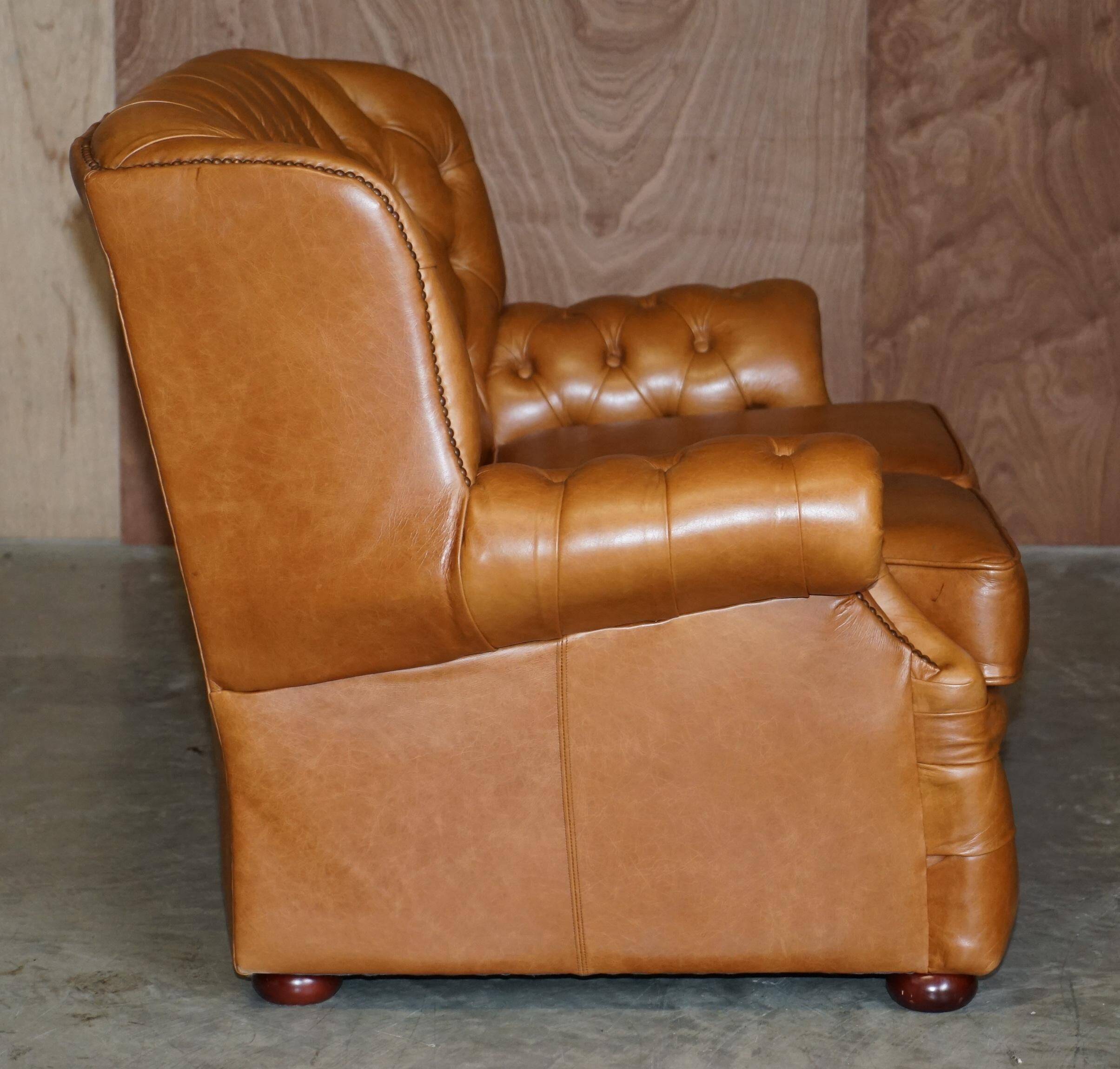 Small Chesterfield leather sofa with a high back.