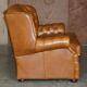 Small Chesterfield leather sofa with a high back.