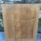 Baroque mirror in gilded wood on a black background.