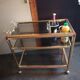 Brass and smoked glass bar trolley with casters