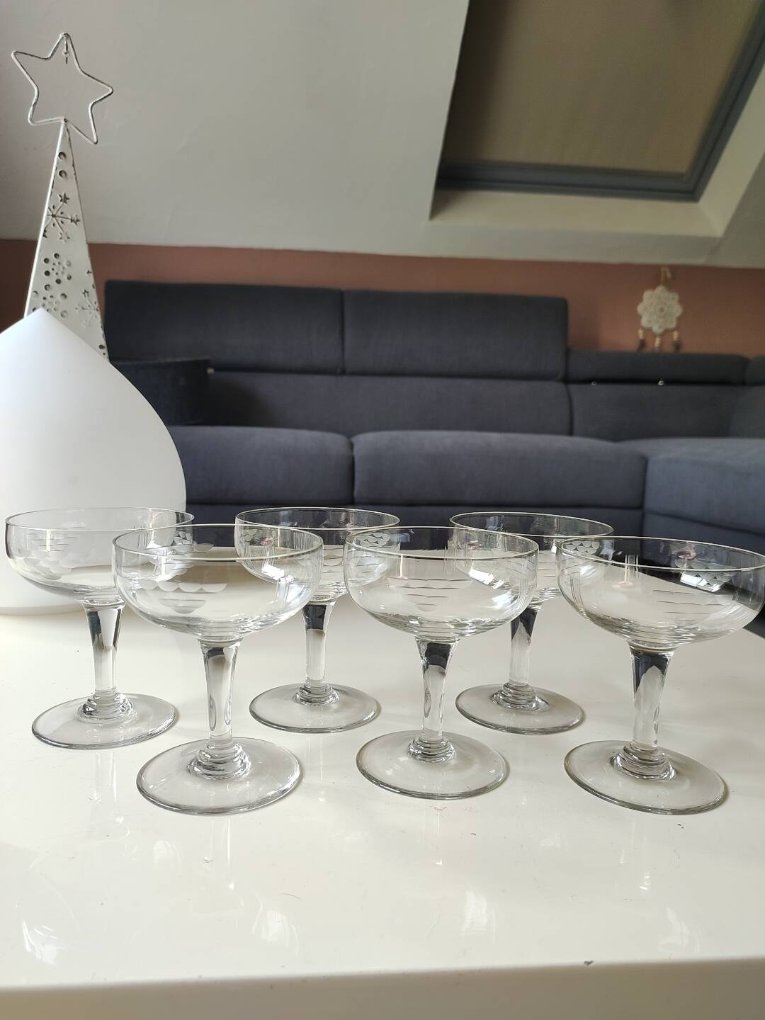 Set of 6 Baccarat-style champagne glasses. Stylized grape cluster decoration.