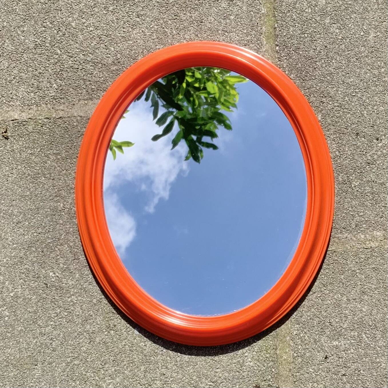 Vintage orange plastic oval wall mirror
