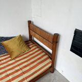 Brutalist style bed with chain and straw