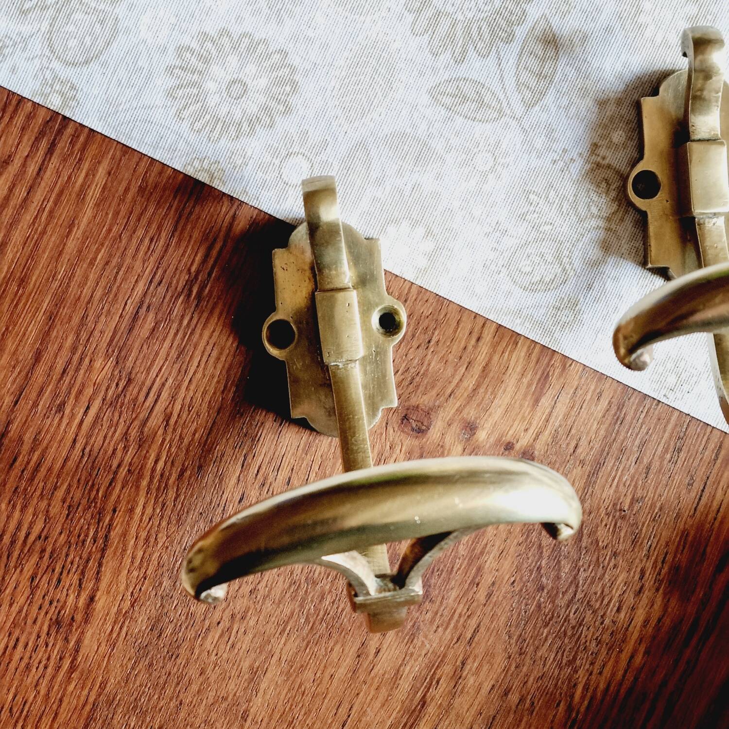 Trio of brass coat hooks or coat racks