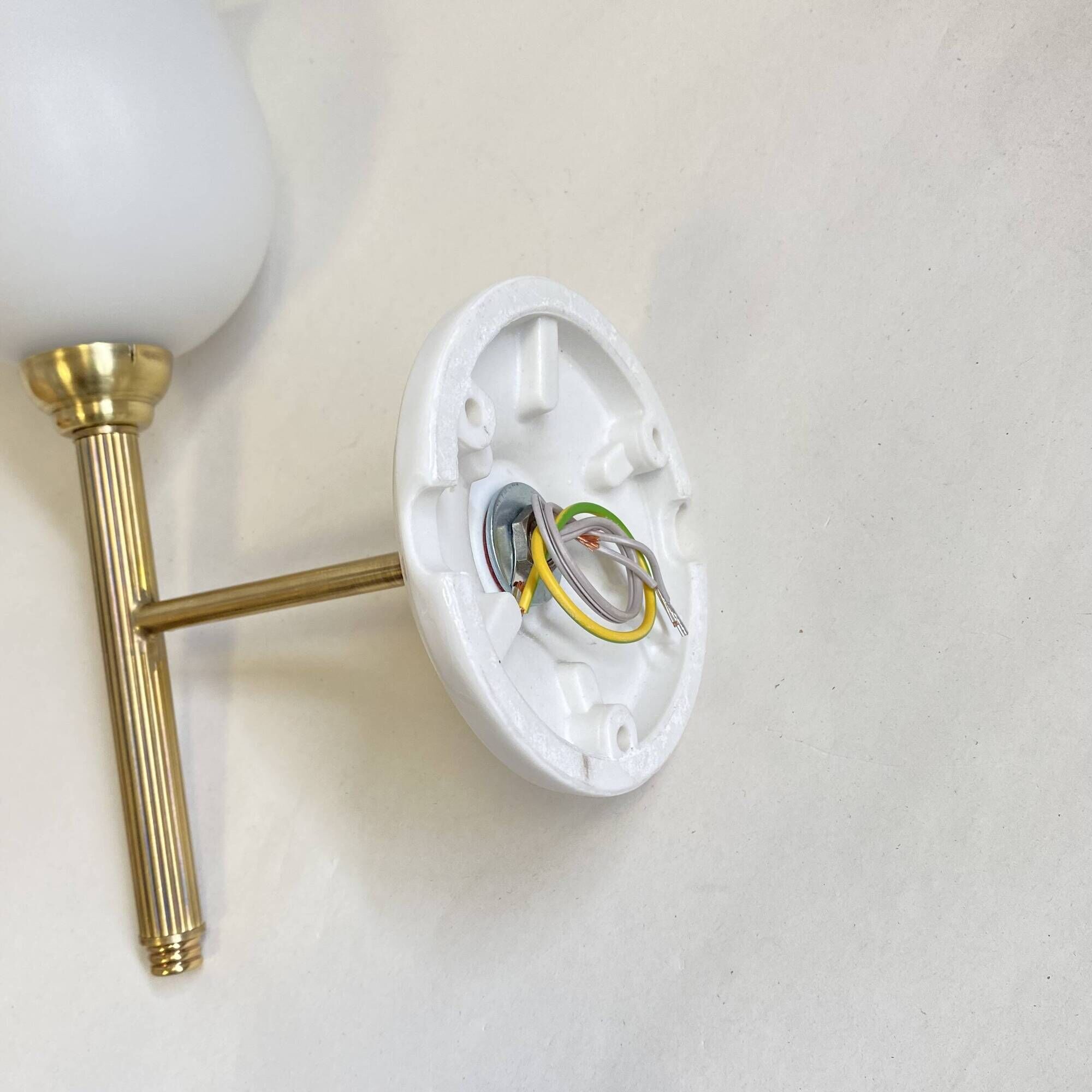 Pair of brass torch wall lights with white opal glass and porcelain