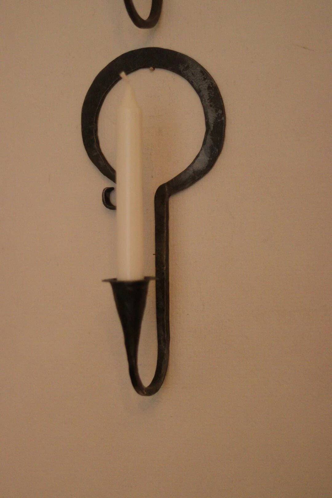 Pair of Swedish wall sconces in wrought iron, mid-20th century style, signed Akta.