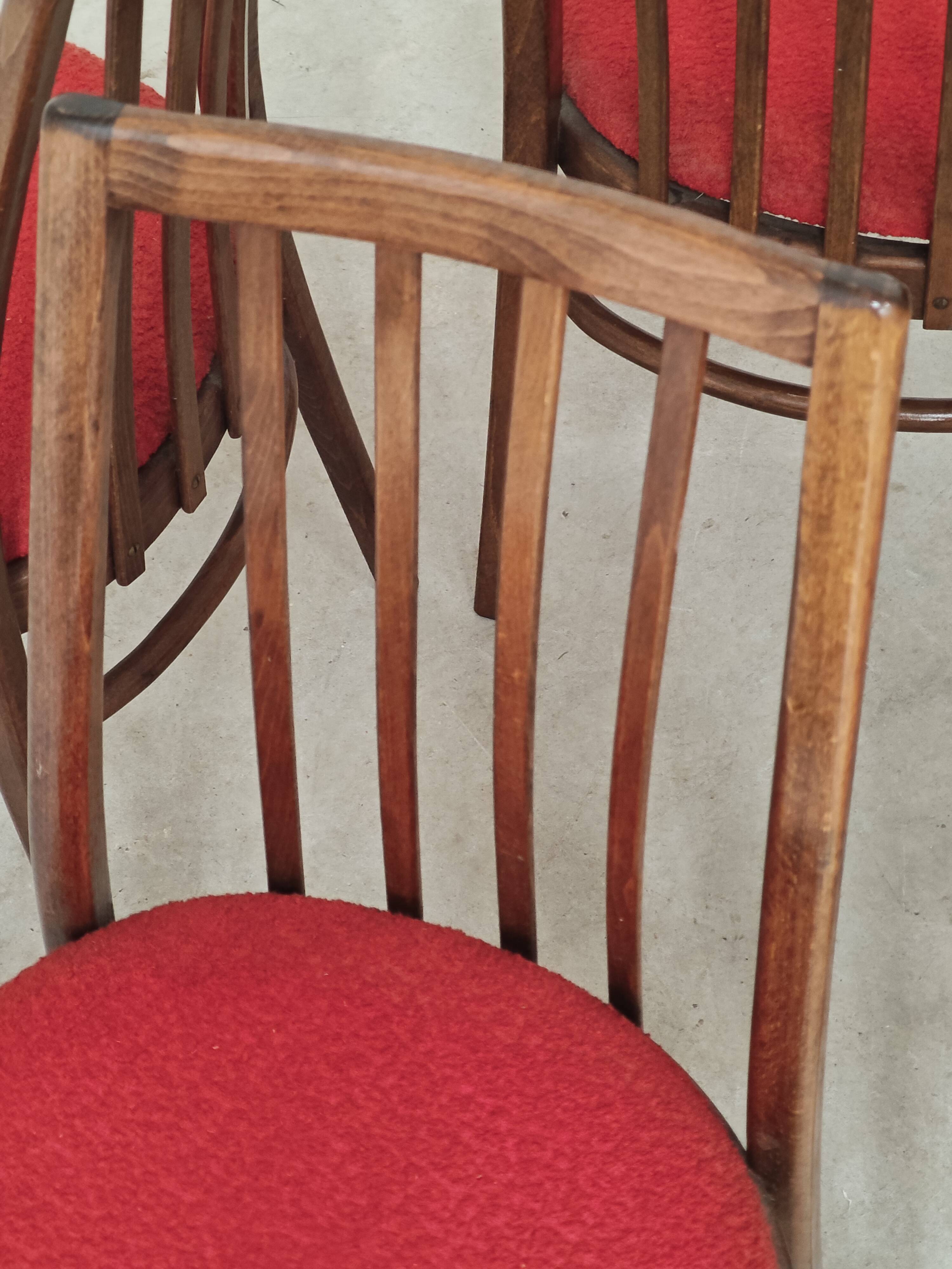 Set of 4 red dining chairs by Antonin Suman for Interier Praha.