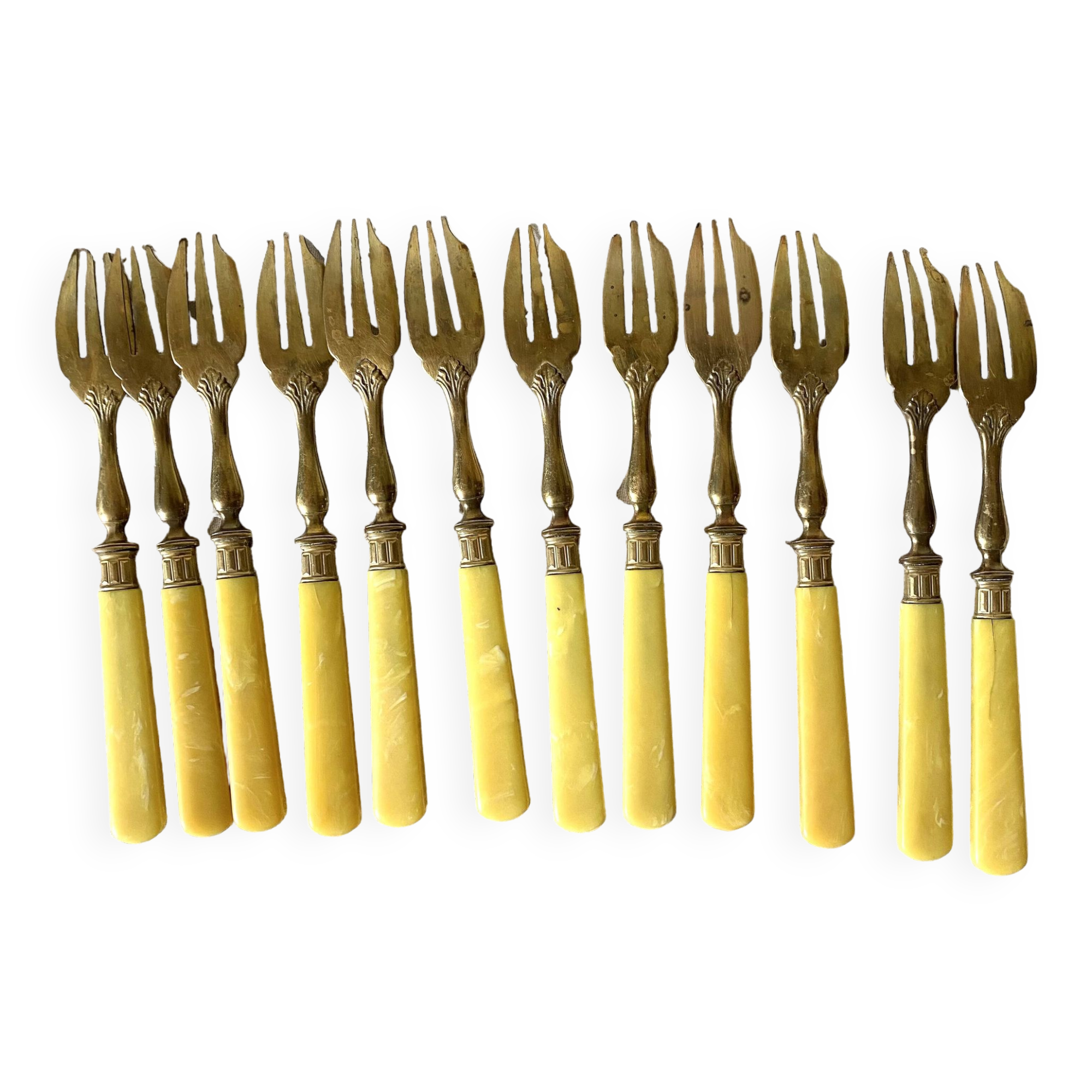 Antique dessert forks in brass and bakelite