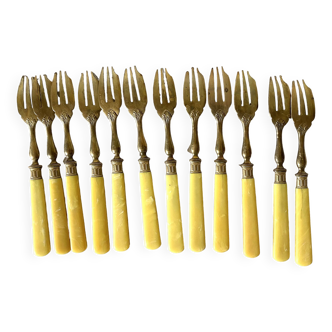 Antique dessert forks in brass and bakelite