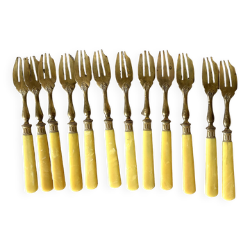 Antique dessert forks in brass and bakelite