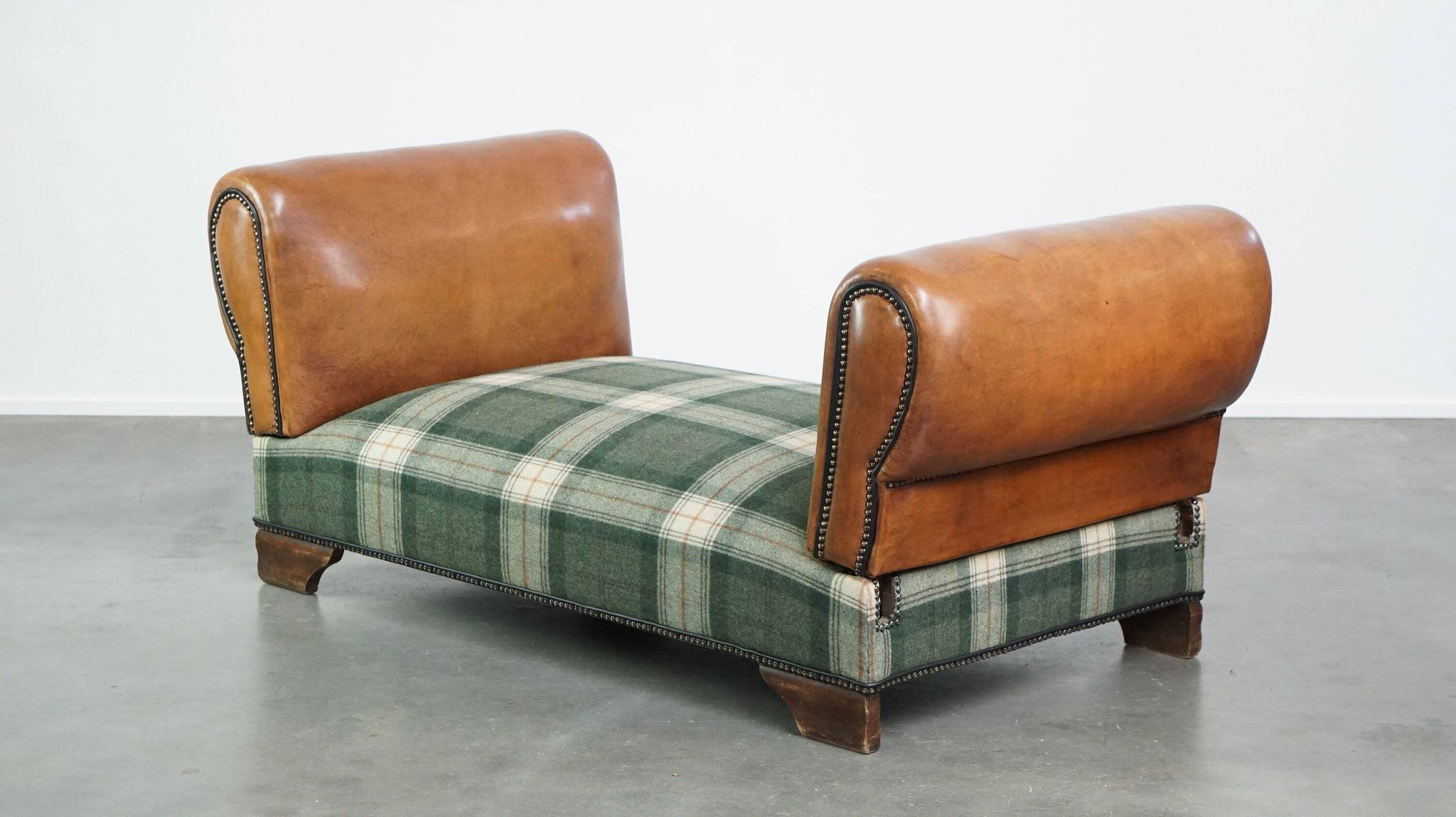Antique daybed reupholstered with sheepskin and Scottish tartan wool