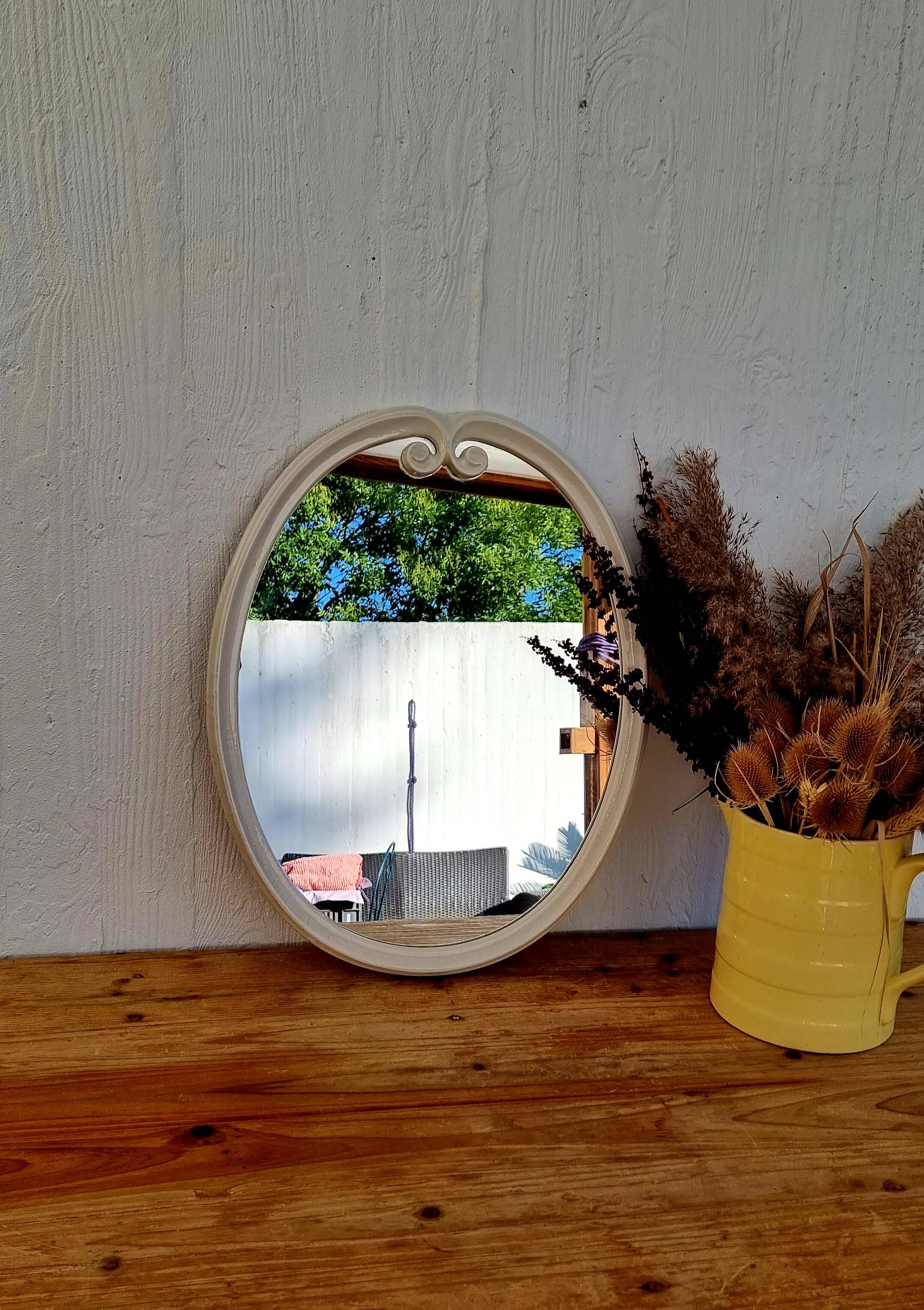 Vintage enamelled metal oval mirror