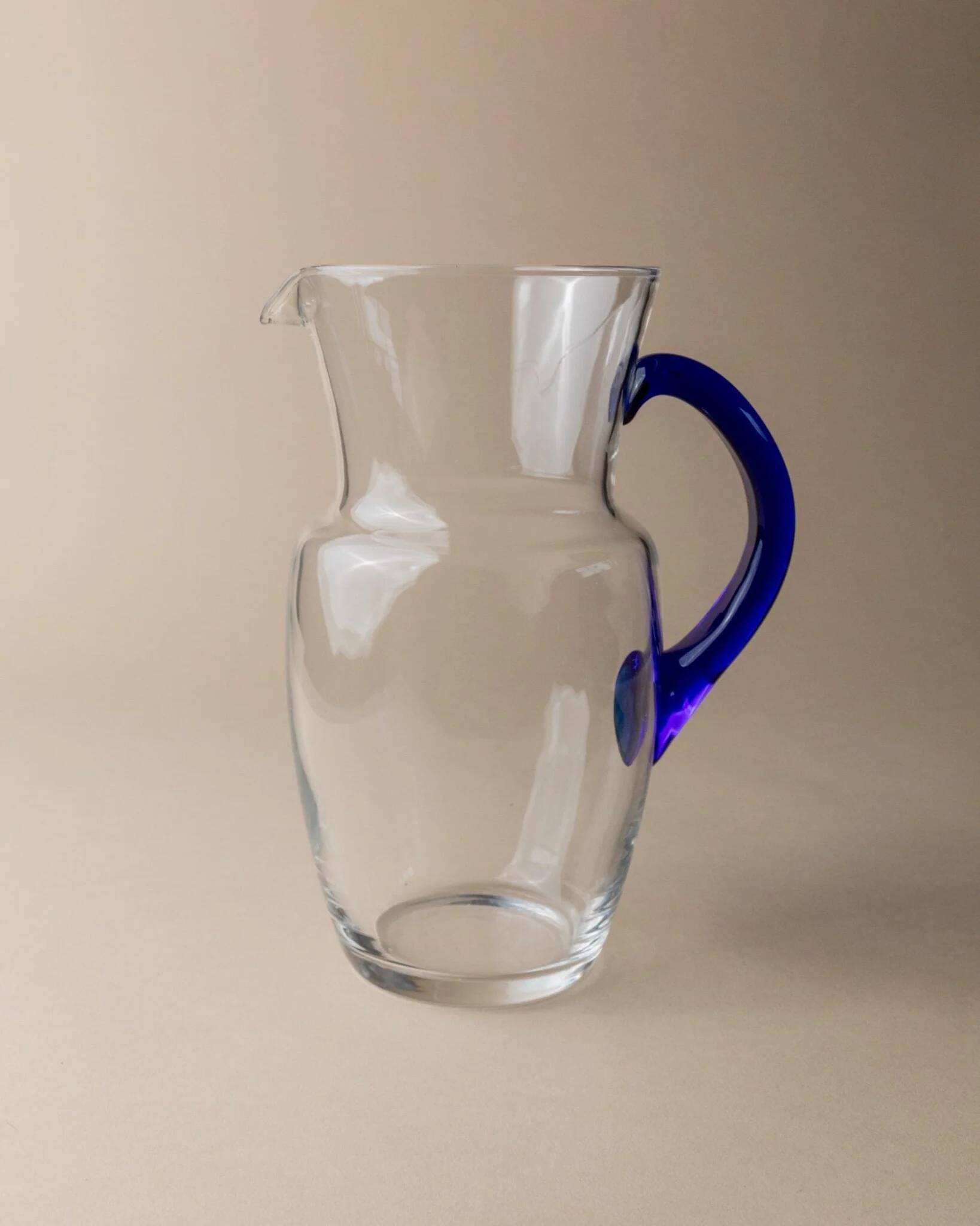 Vintage glass pitcher - clear glass with blue handle - Mid-Century design from Italy in the 1970s - elegant table decoration, retro gift idea.