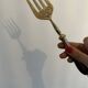 Engraved meat fork in silver and gold metal