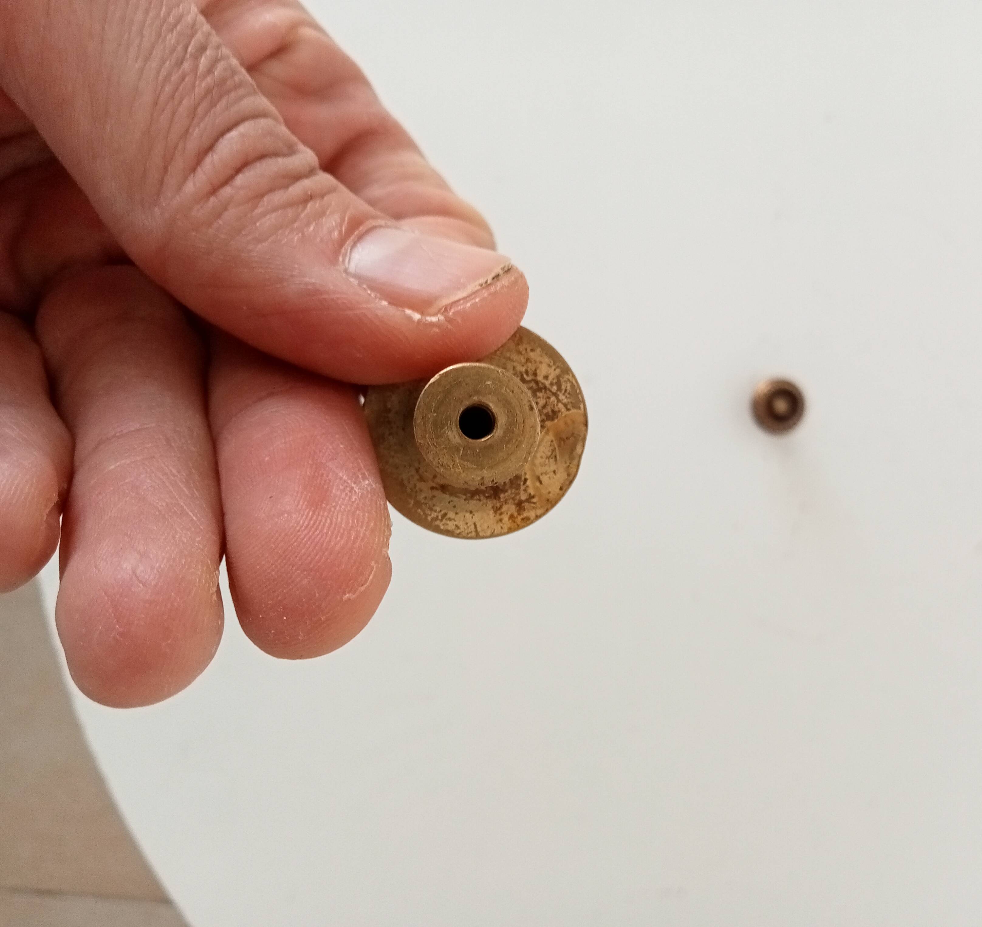 Pair of antique furniture knobs in gilded brass.