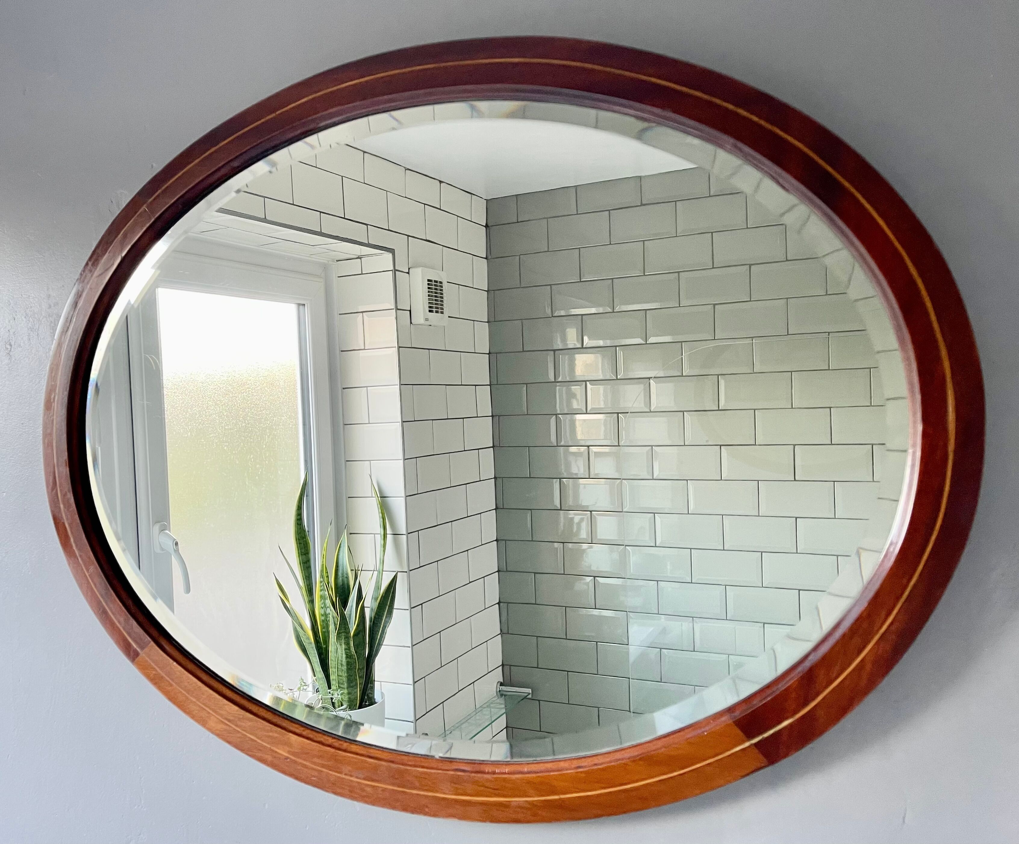 Vintage oval bevelled mirror mahogany frame
