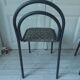 Industrial chair with a tubular metal frame in slate grey.