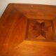 Square cherry wood table with drop leaves.