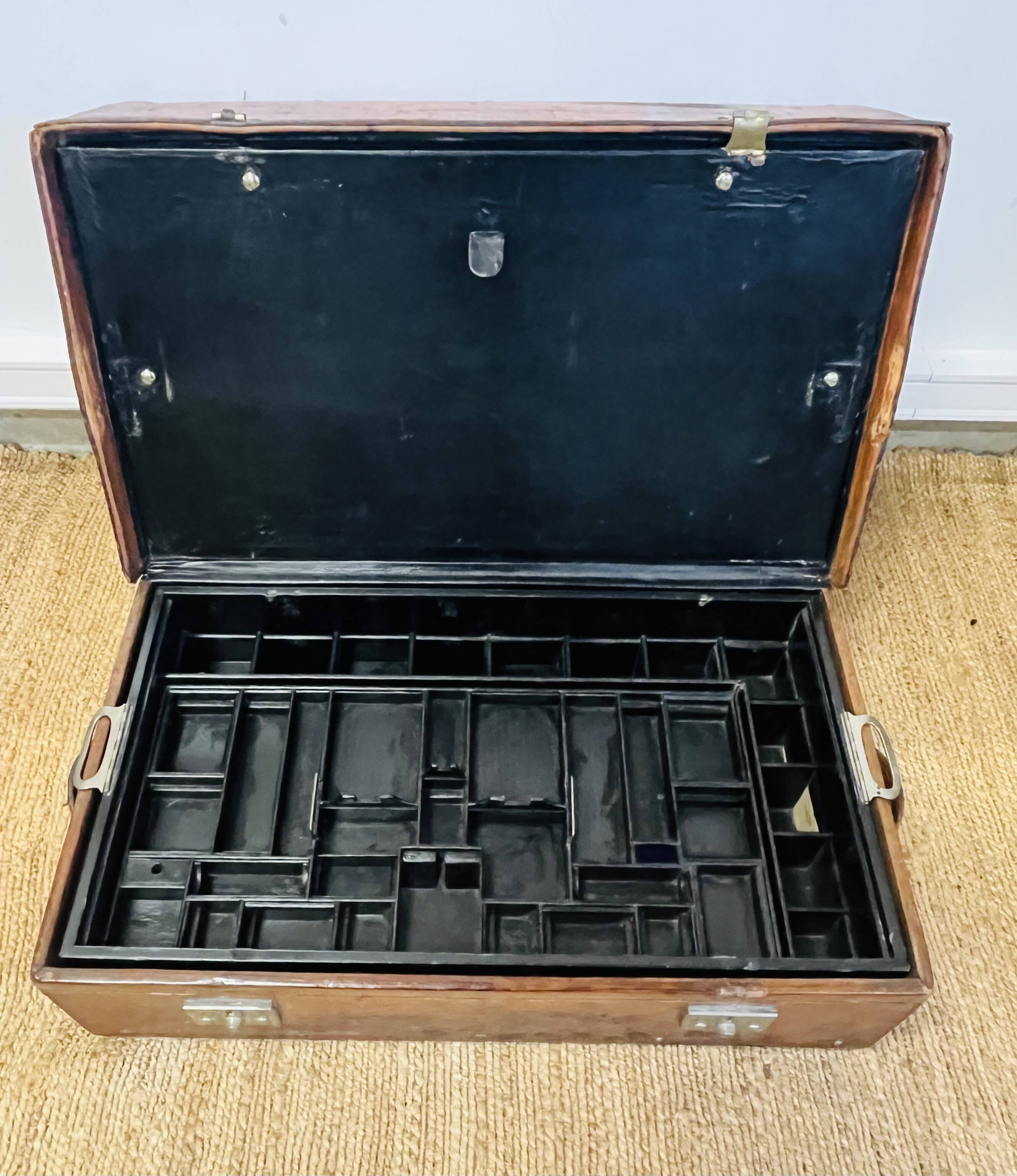 Large Gustave Keller leather trunk with multiple compartments