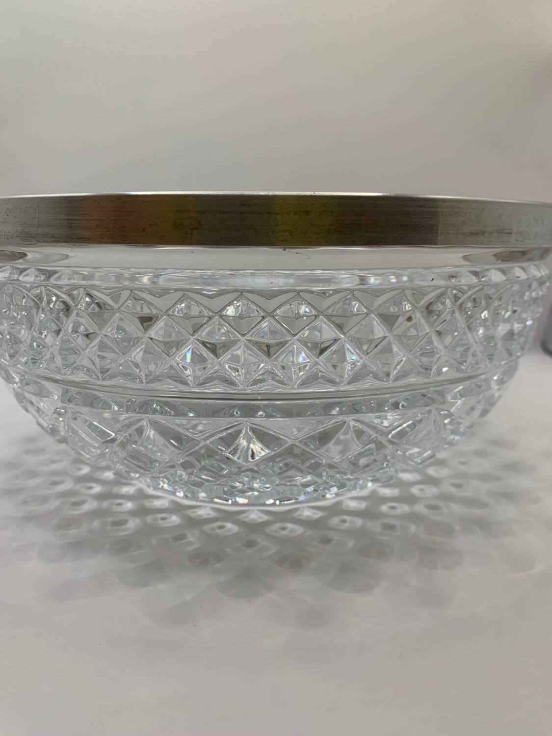 Chiseled glass (crystal?) salad bowl with silver metal edge