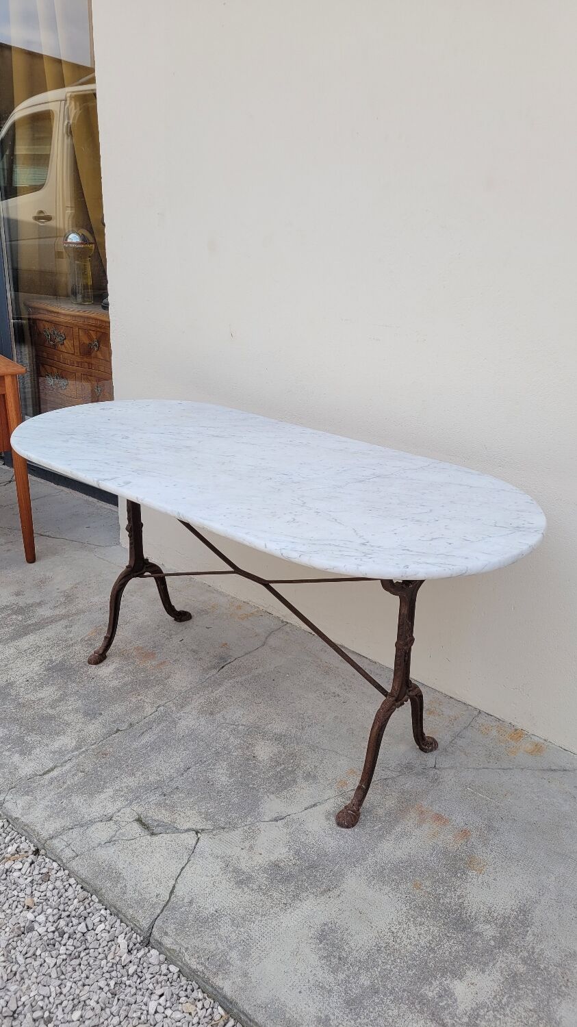 Restaurant bistro table in oval marble and decorated cast iron bases -1m51
