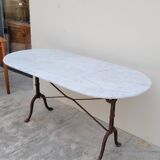 Restaurant bistro table in oval marble and decorated cast iron bases -1m51