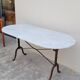 Restaurant bistro table in oval marble and decorated cast iron bases -1m51