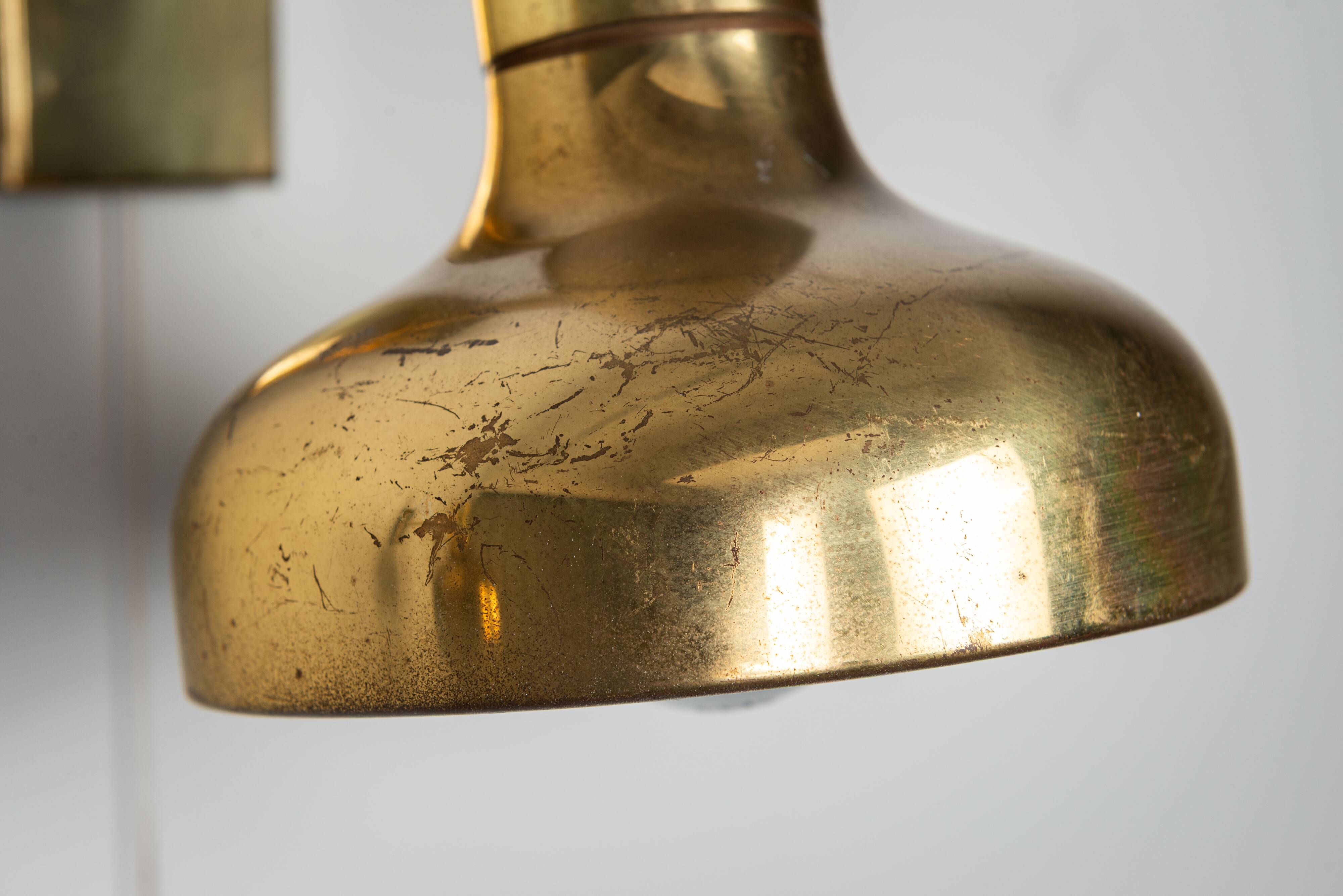 Set of three brass adjustable wall lamps