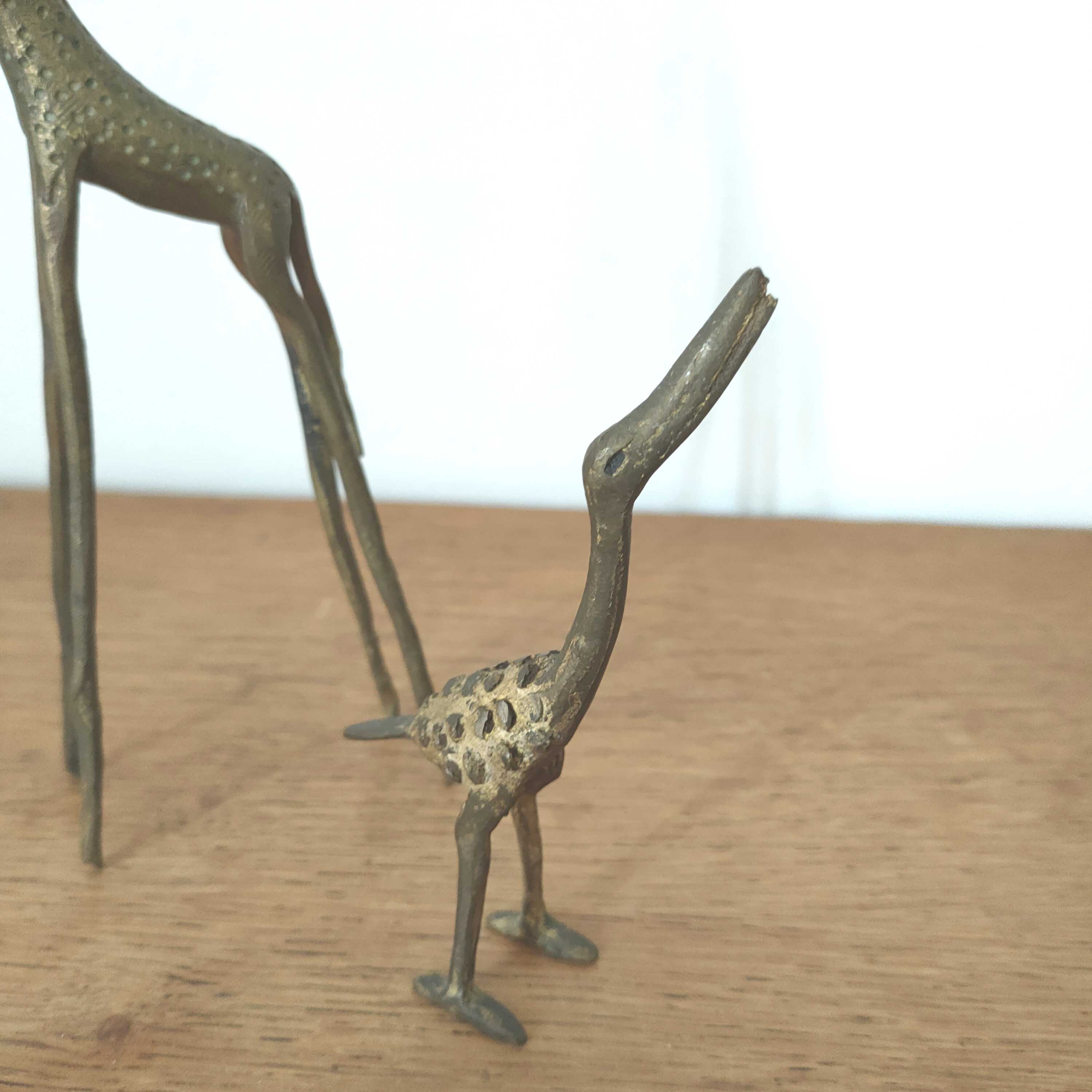 Giraffe and brass bird