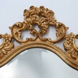 French Rococo or Baroque style facet-cut crest mirror in gilded carved wood