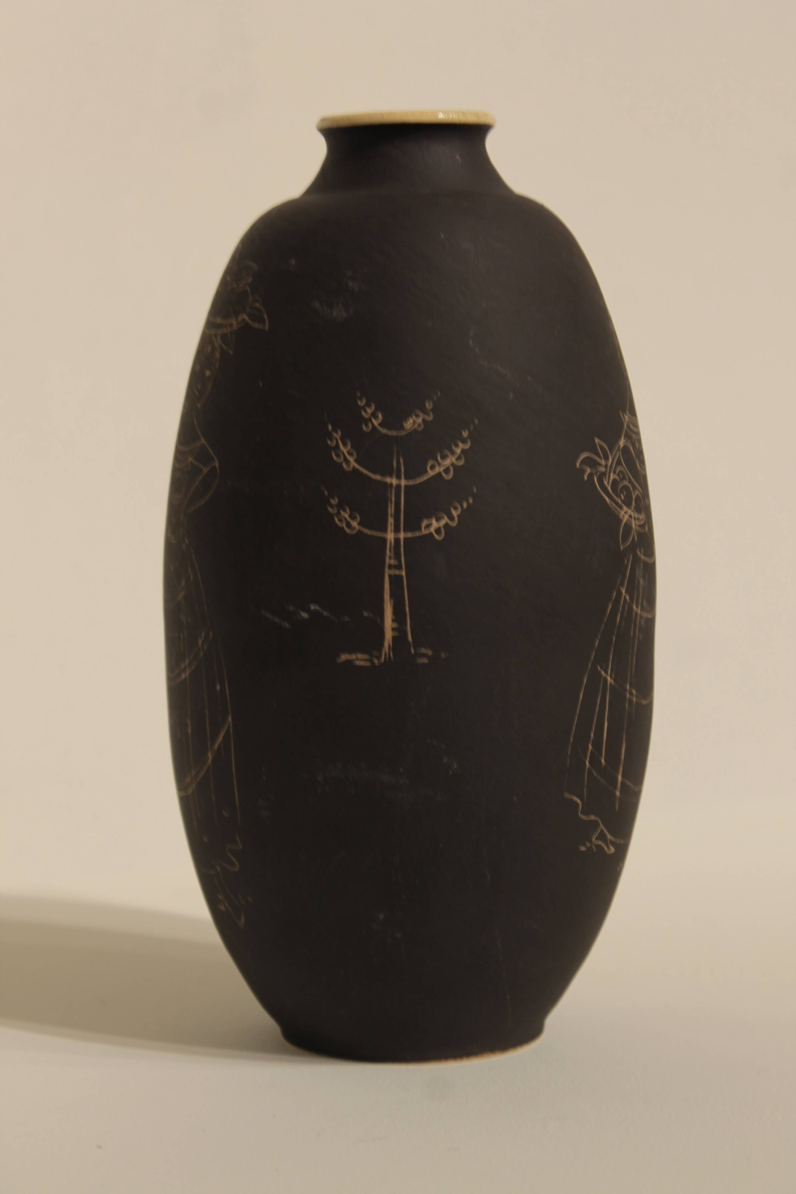 Ceramic vase decorated with women and a tree.